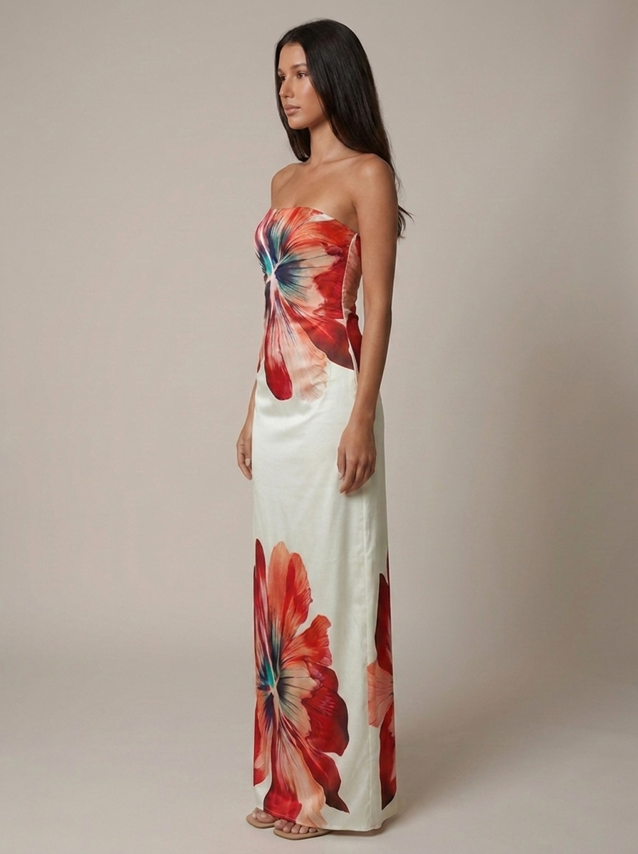 Side profile of white strapless maxi dress with red hibiscus-style print, floor-length skirt