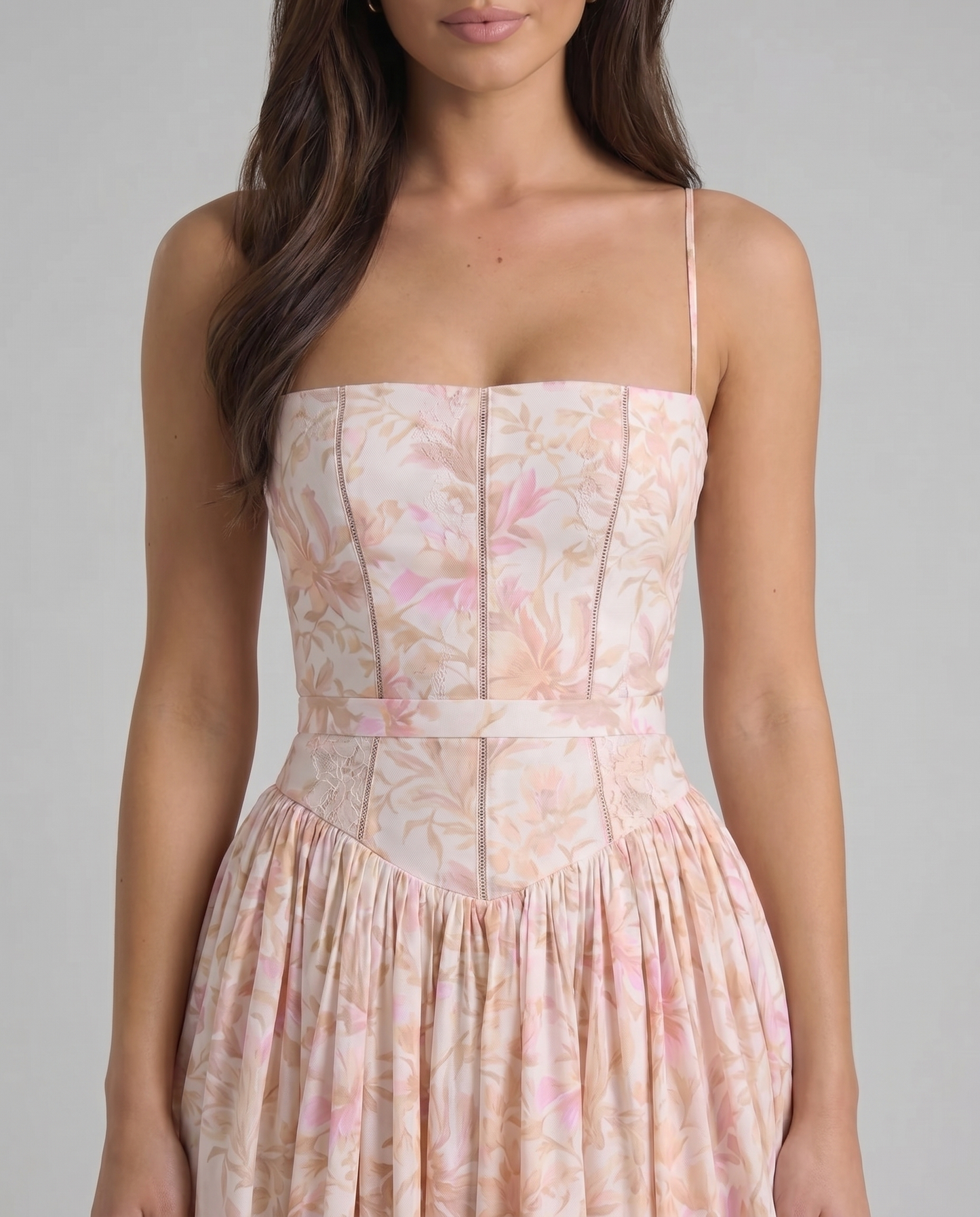 Detail of sweetheart neckline and bodice paneling on peach printed midi dress