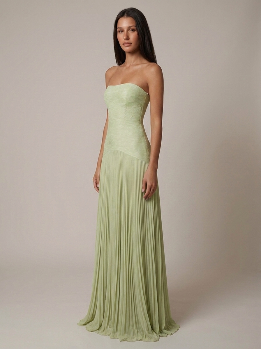 Angled front view of green forest maxi dress with asymmetrical waist seam and pleated skirt