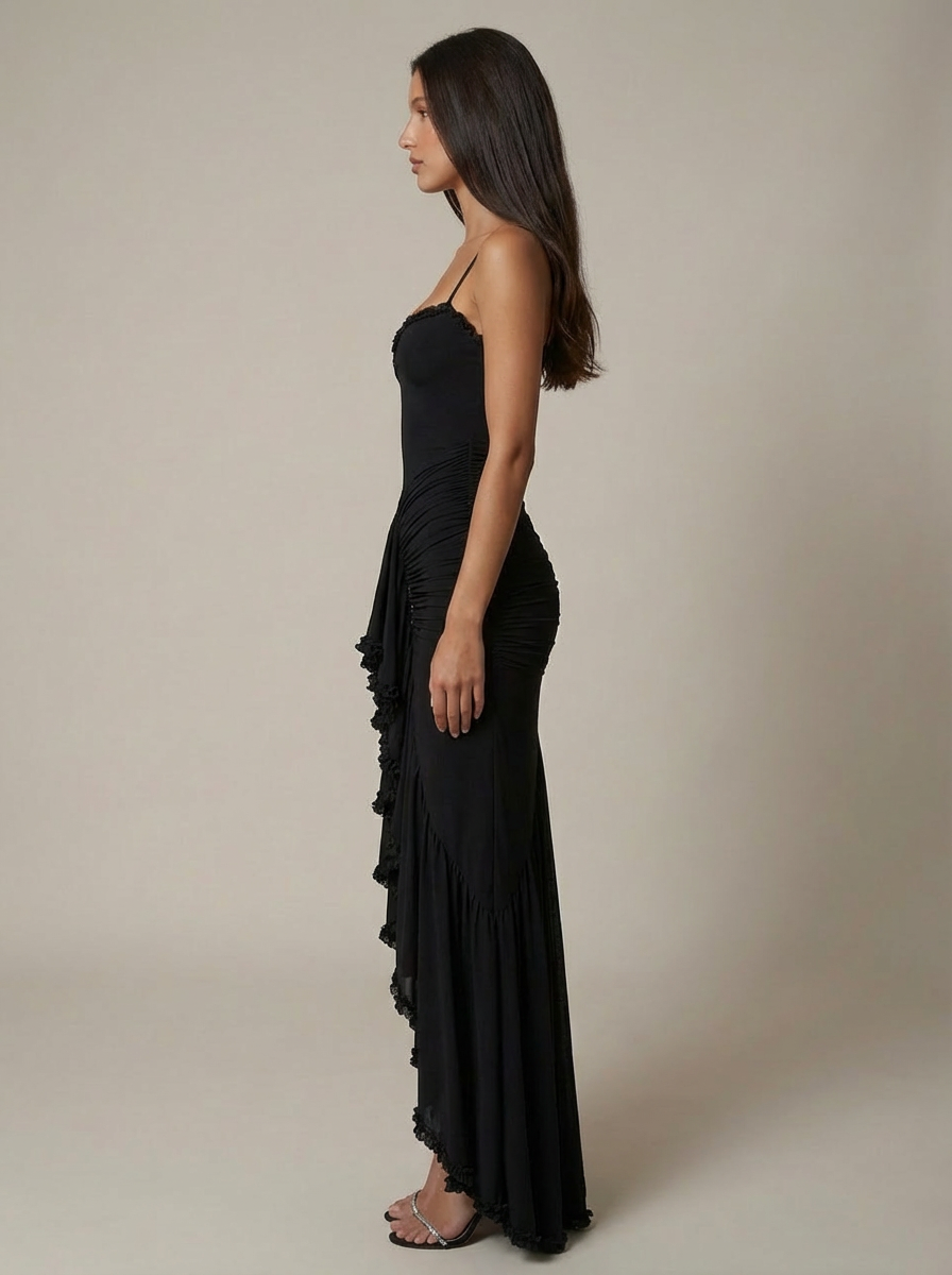 Side view black spaghetti strap maxi dress with fitted ruched silhouette and draped skirt