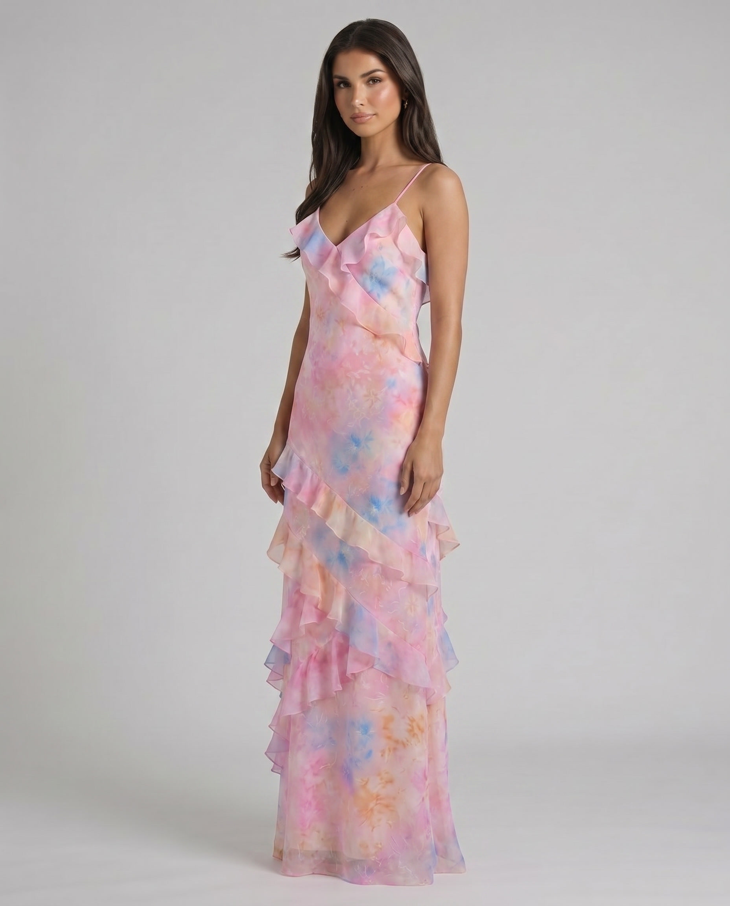 Three-quarter front pose of pink tie-dye ruffle maxi dress with v-neck and layered hemline