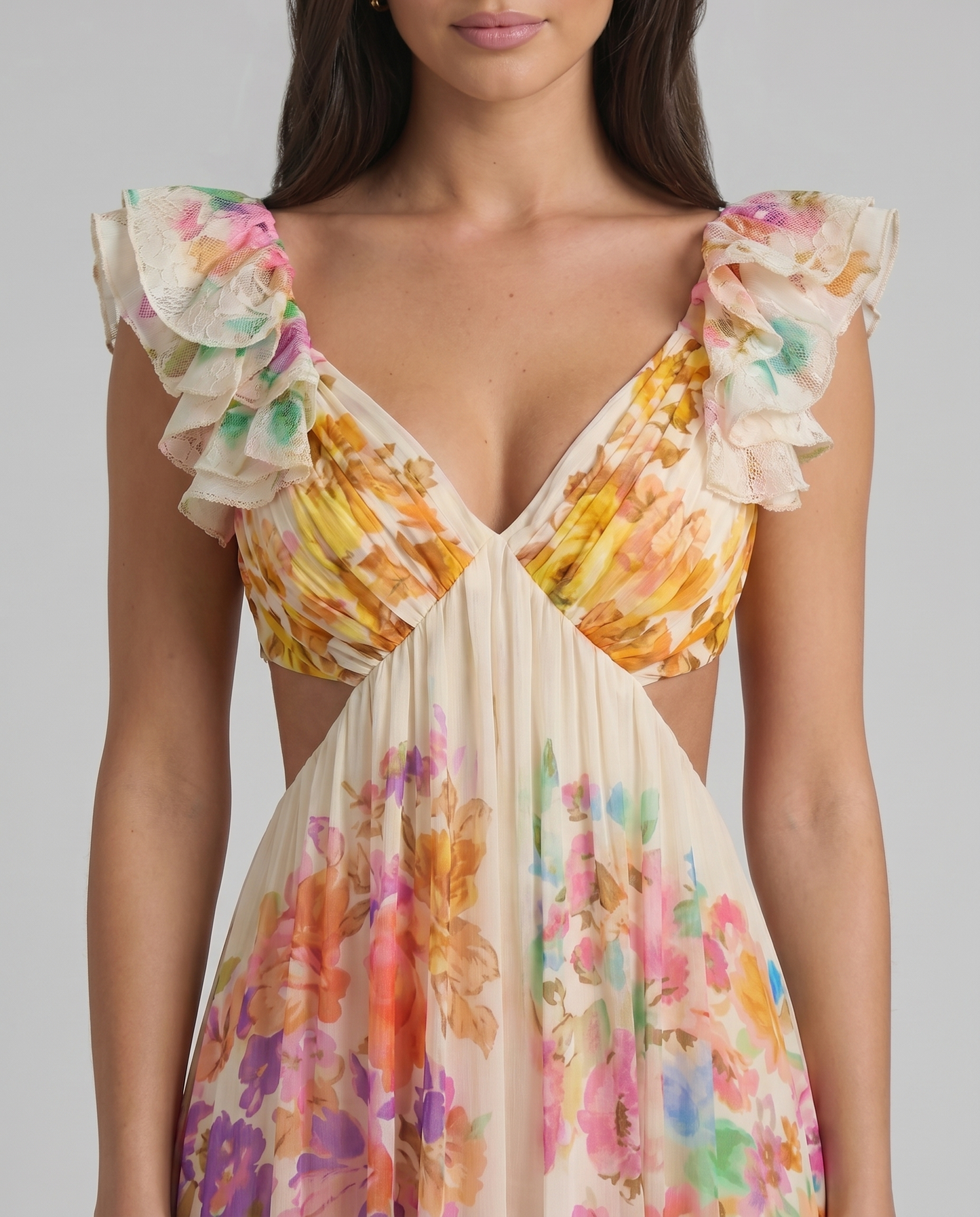 Close-up of V-neck bodice on multicolor floral midi dress with layered ruffle sleeves and pleats
