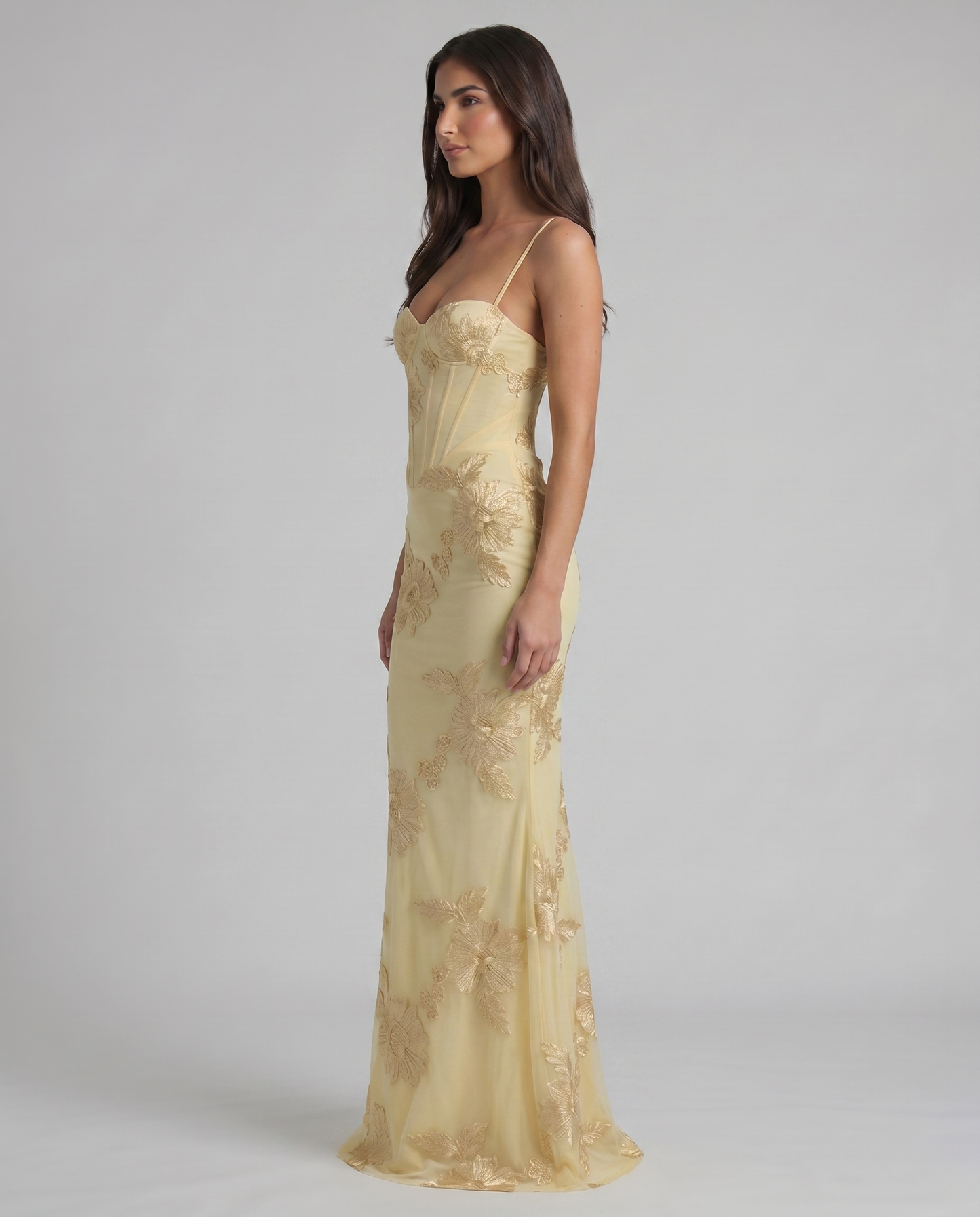 Profile shot of yellow embroidered maxi dress showing smooth skirt drape and corset-style top
