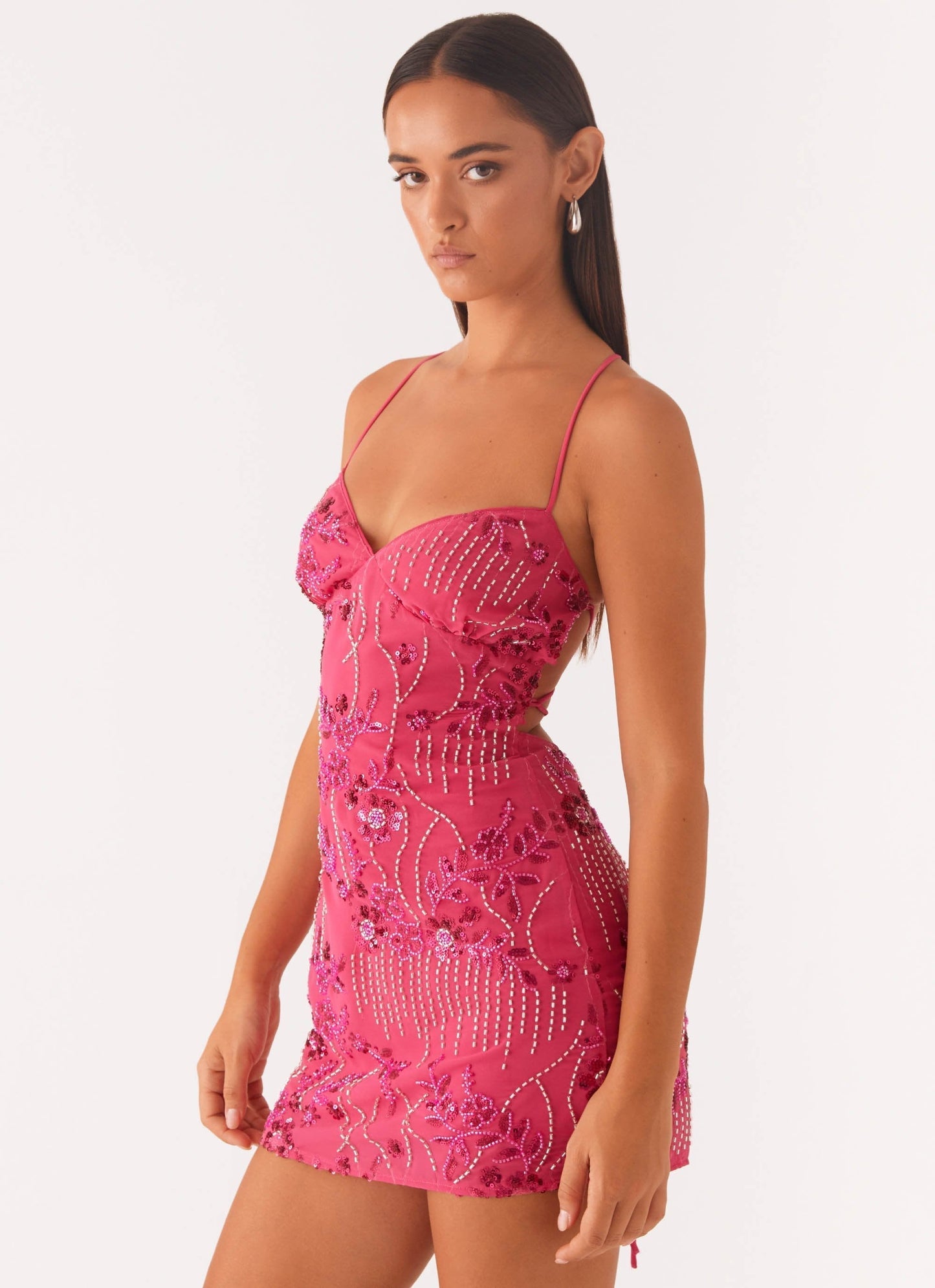 Three-quarter front view of fuchsia beaded sequin mini dress with sweetheart bodice and sparkle detail