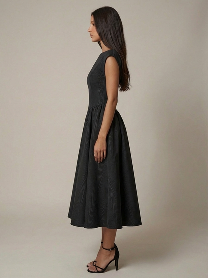 Side profile black midi dress with cap sleeves, cinched waist and A-line skirt