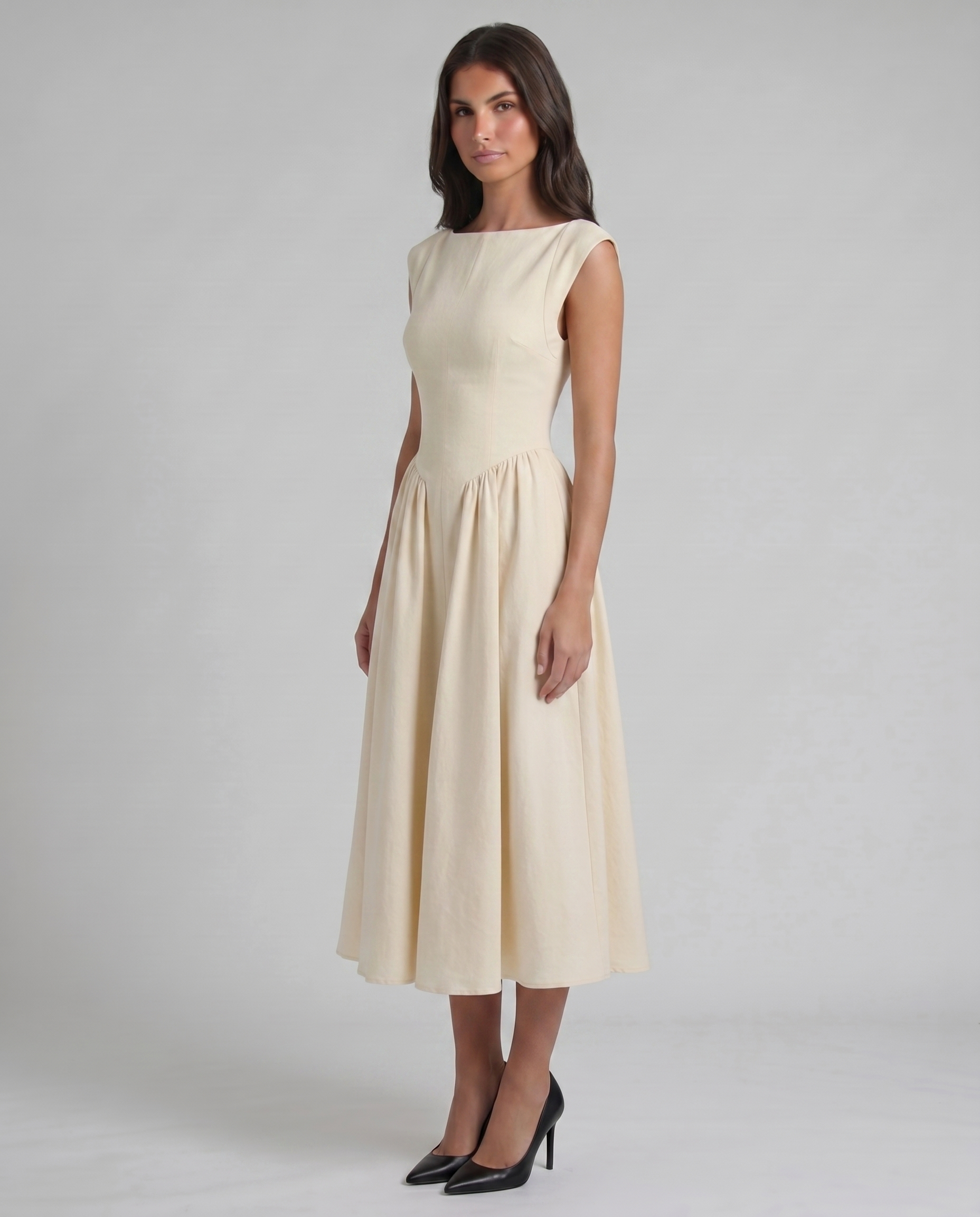 Three-quarter view of white midi dress with fitted bodice, cap sleeves, and flared skirt