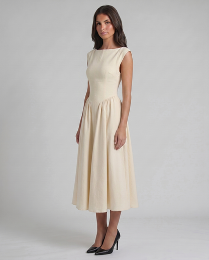 Three-quarter view of white midi dress with fitted bodice, cap sleeves, and flared skirt