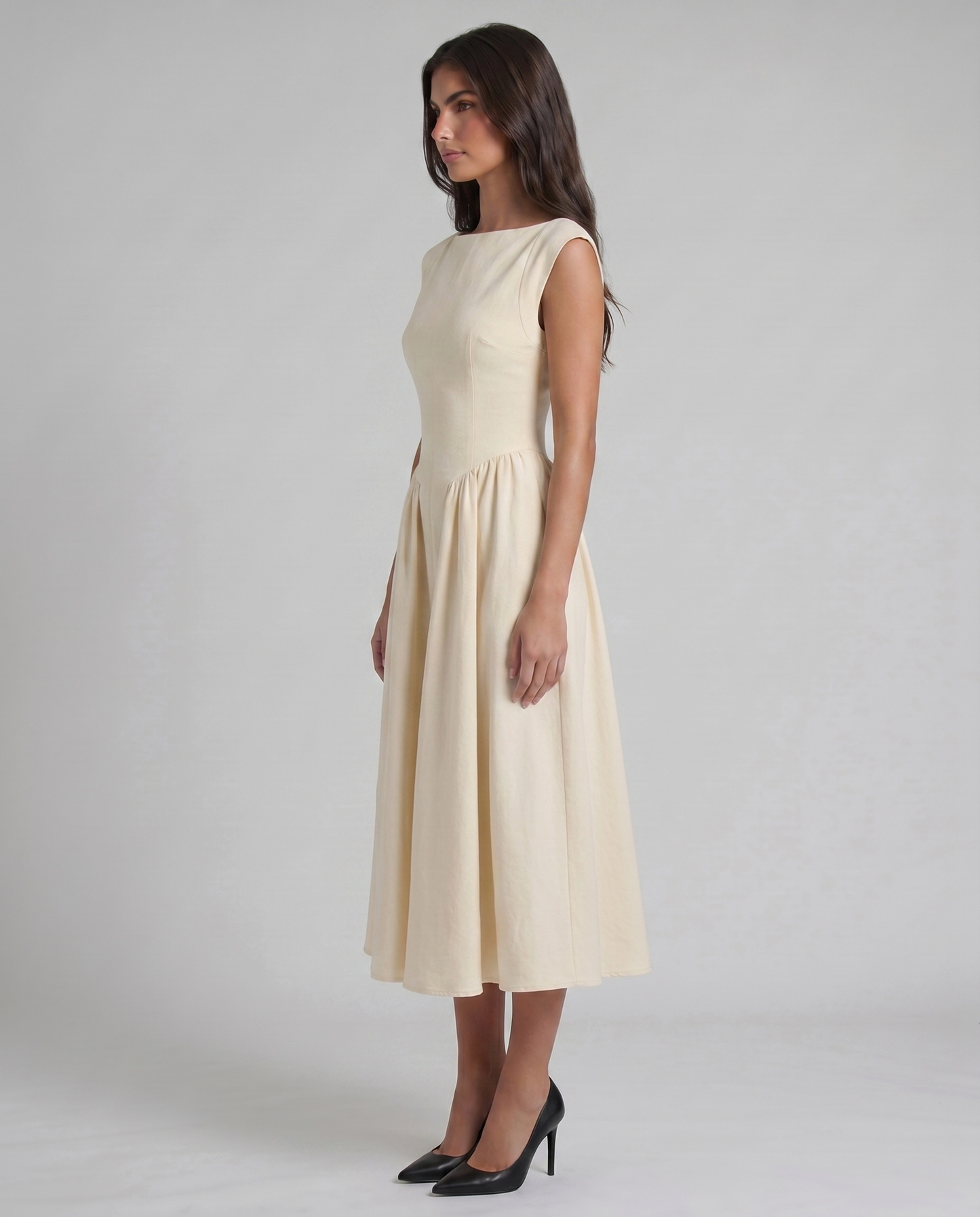 Side view of white boat-neck midi dress showing tailored waist seam and A-line skirt