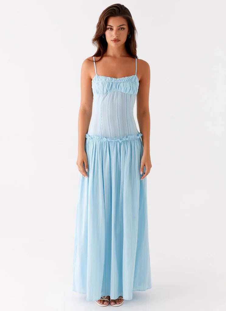 Women ivory corset maxi dress with thin straps and gathered floor length skirt