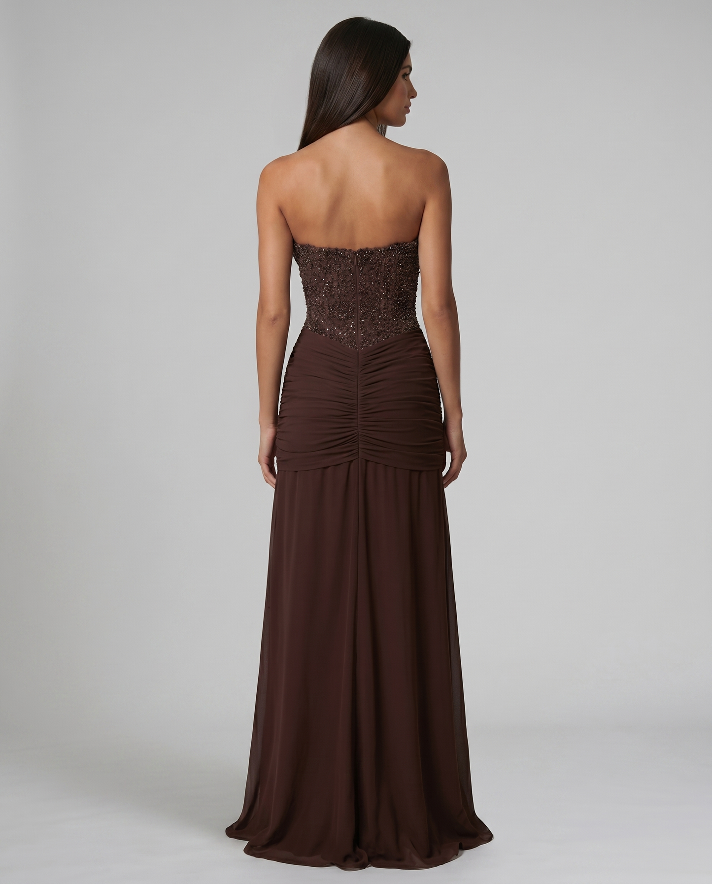 Upper back view of brown strapless maxi dress with beaded bodice and center back seam