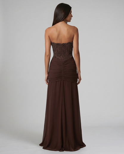 Upper back view of brown strapless maxi dress with beaded bodice and center back seam
