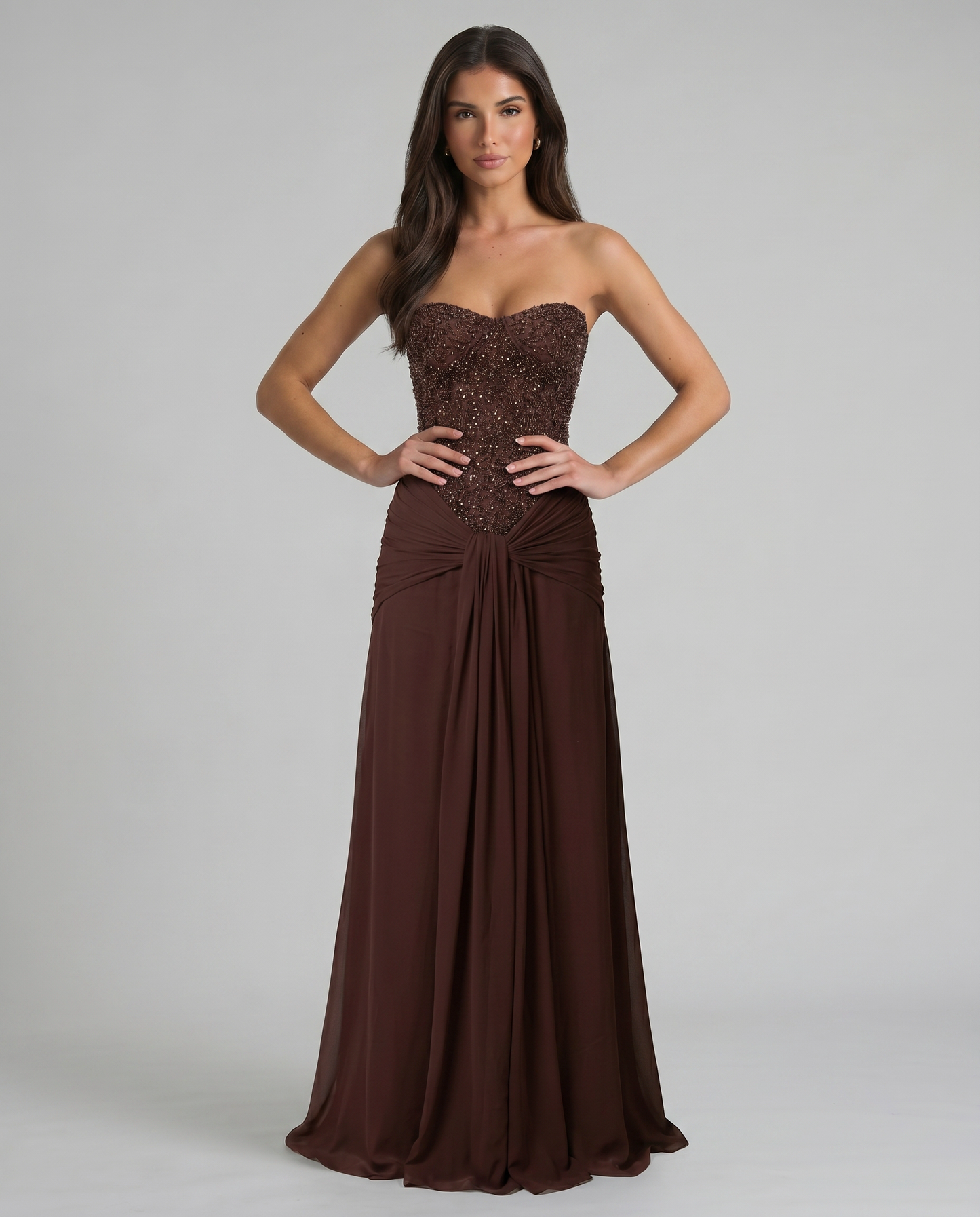 Front torso view of brown strapless maxi dress highlighting beaded bodice and ruched waist detail