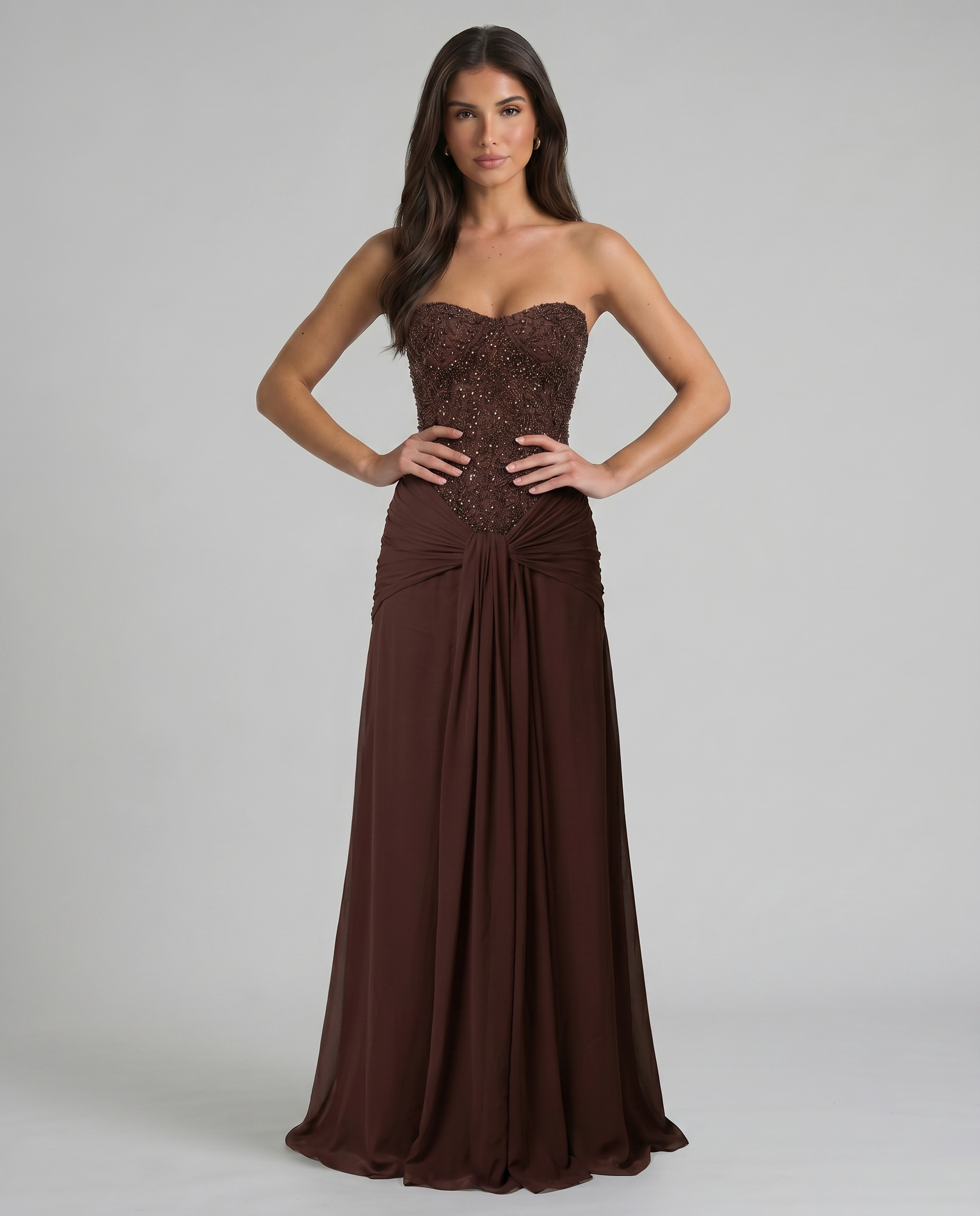 Front torso view of brown strapless maxi dress highlighting beaded bodice and ruched waist detail