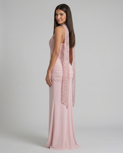 Side-back view of pink maxi dress with long sequin scarf tails, ruched back waist, and floor-length skirt