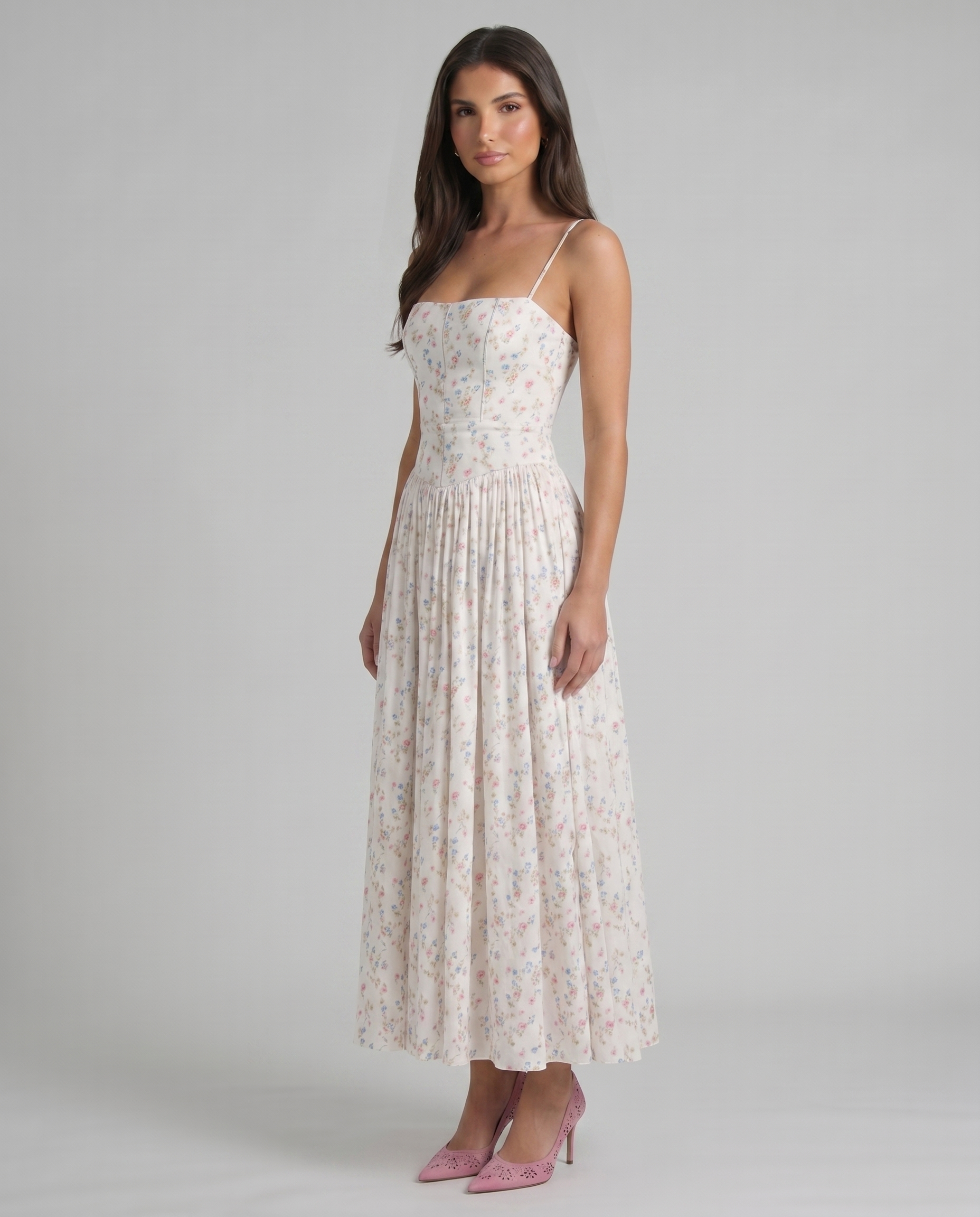 Three-quarter front view of cream floral midi dress highlighting fitted top, airy skirt and midi hem