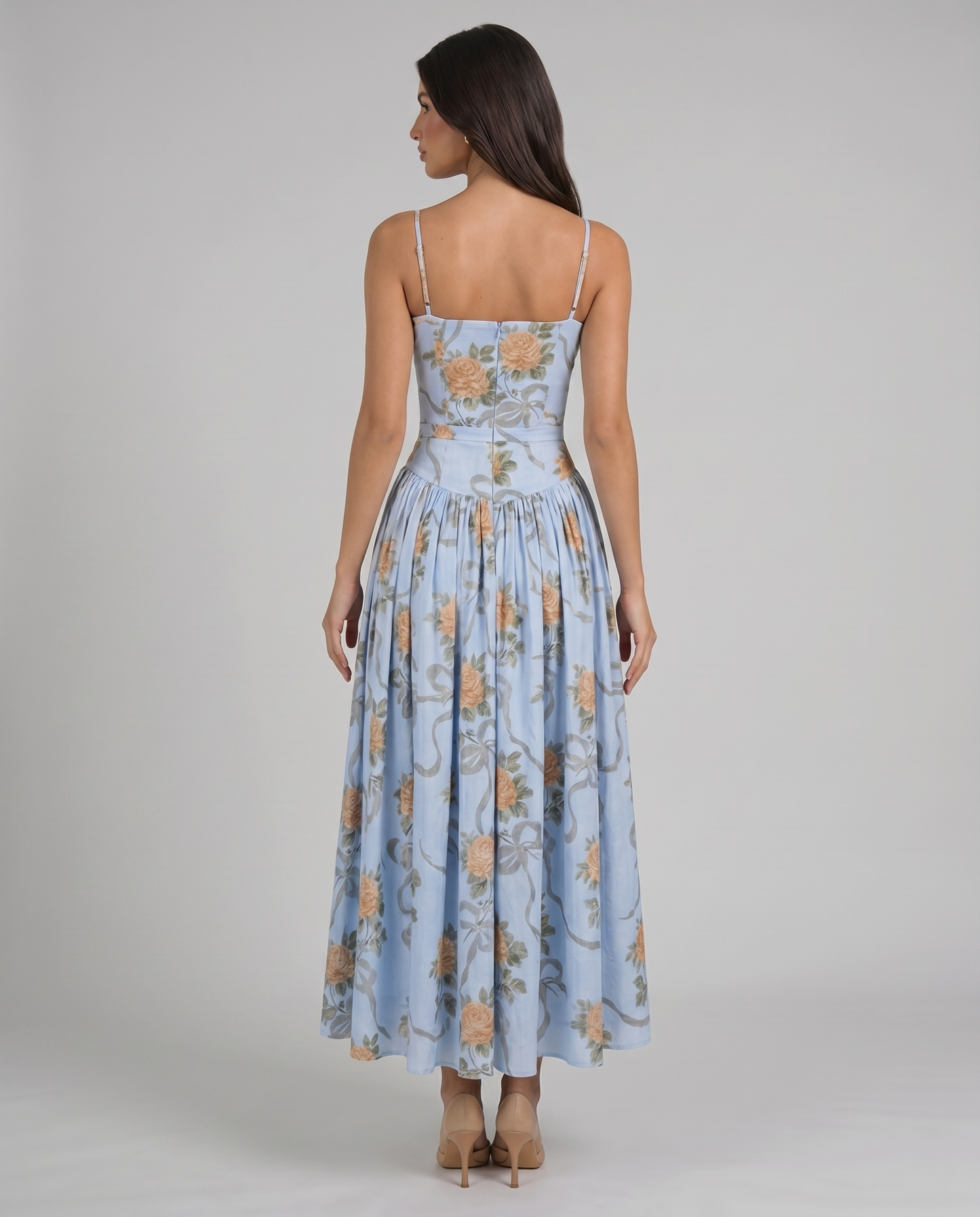 Back bodice detail of blue floral midi dress showing center zipper, straight back and slim straps