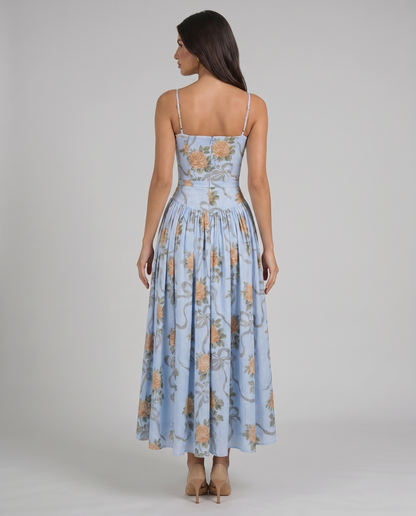 Back bodice detail of blue floral midi dress showing center zipper, straight back and slim straps