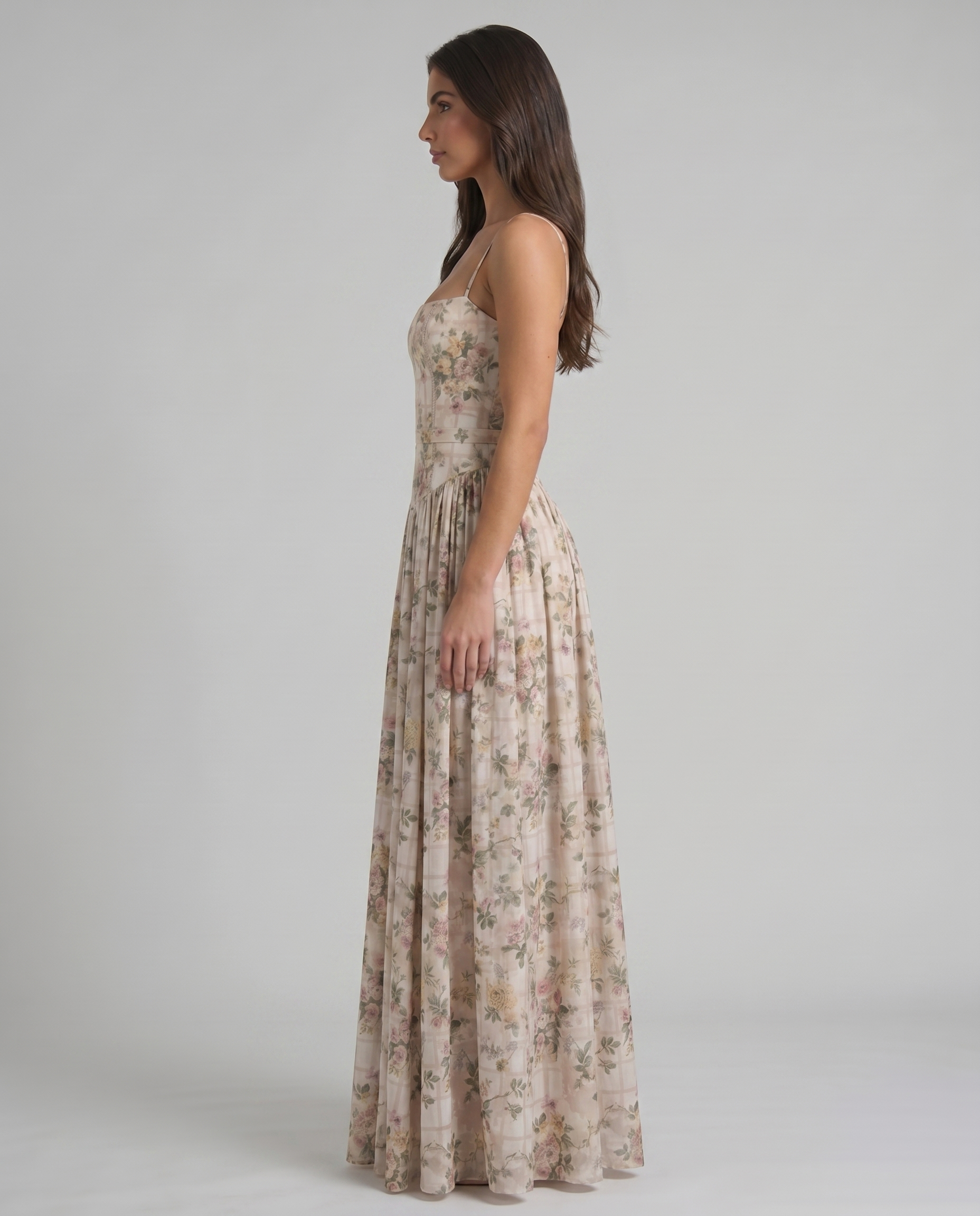 Back view of green floral midi dress with slim straps, fitted waist and flowing midi skirt