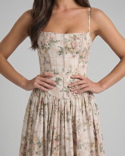 Close-up of green floral midi dress bodice with square neckline, vertical seams and waist panel
