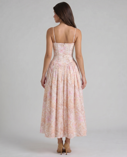 Rear three-quarter view peach floral midi dress with structured bodice and flowing skirt