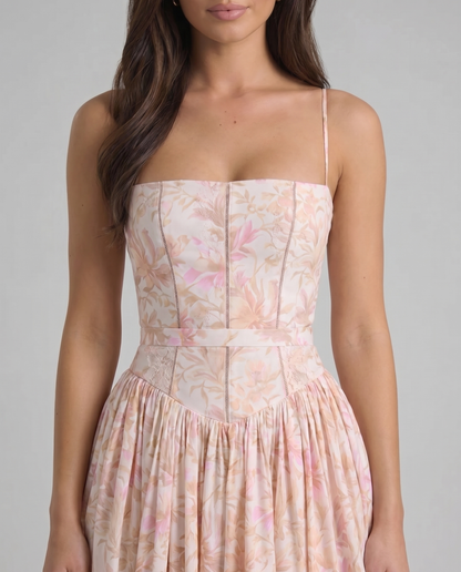 Detail of sweetheart neckline and bodice paneling on peach printed midi dress