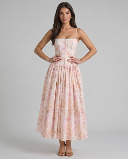 Peach floral midi dress with corset-style bodice, spaghetti straps, and full gathered skirt
