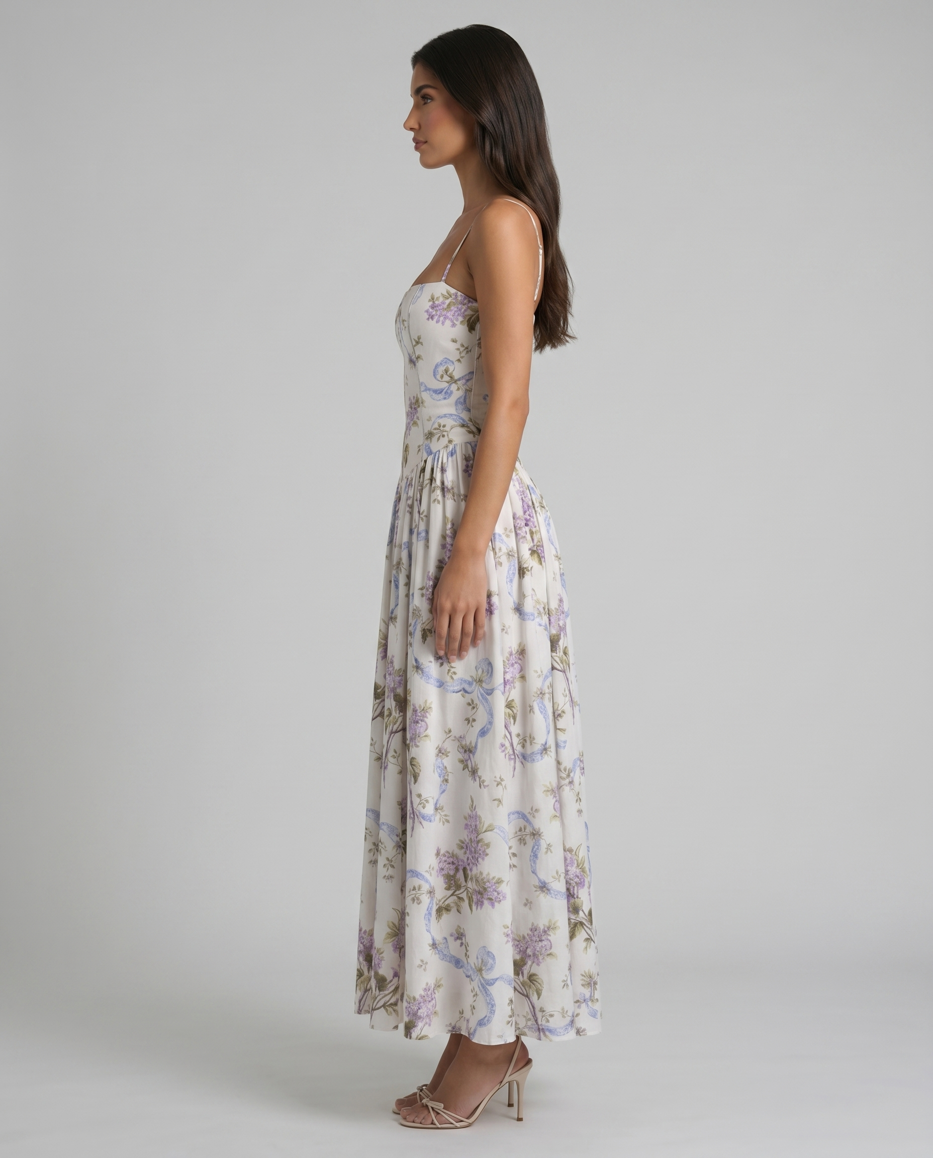 Side profile of purple floral midi dress with structured corset bodice and softly draped skirt