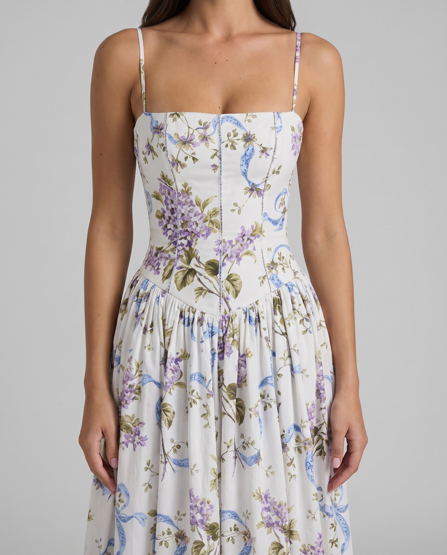 Detailed bodice view of purple floral midi dress with spaghetti straps, boning seams, and print