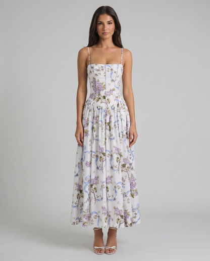 Full-length front shot of purple floral midi dress with corset-style waist and flowing skirt panels