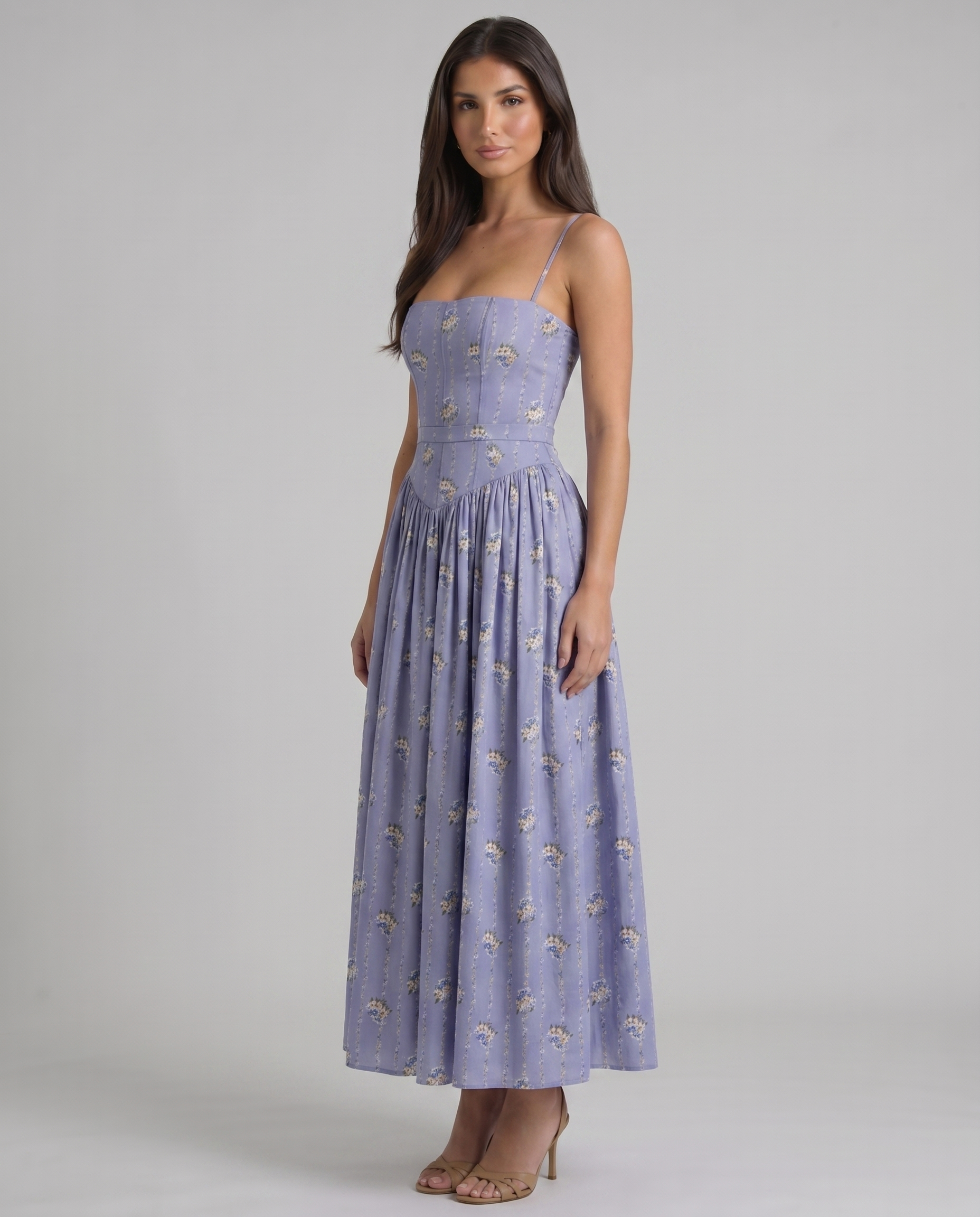 Angled front view of violet midi dress with floral print, spaghetti straps, fitted waist and midi skirt