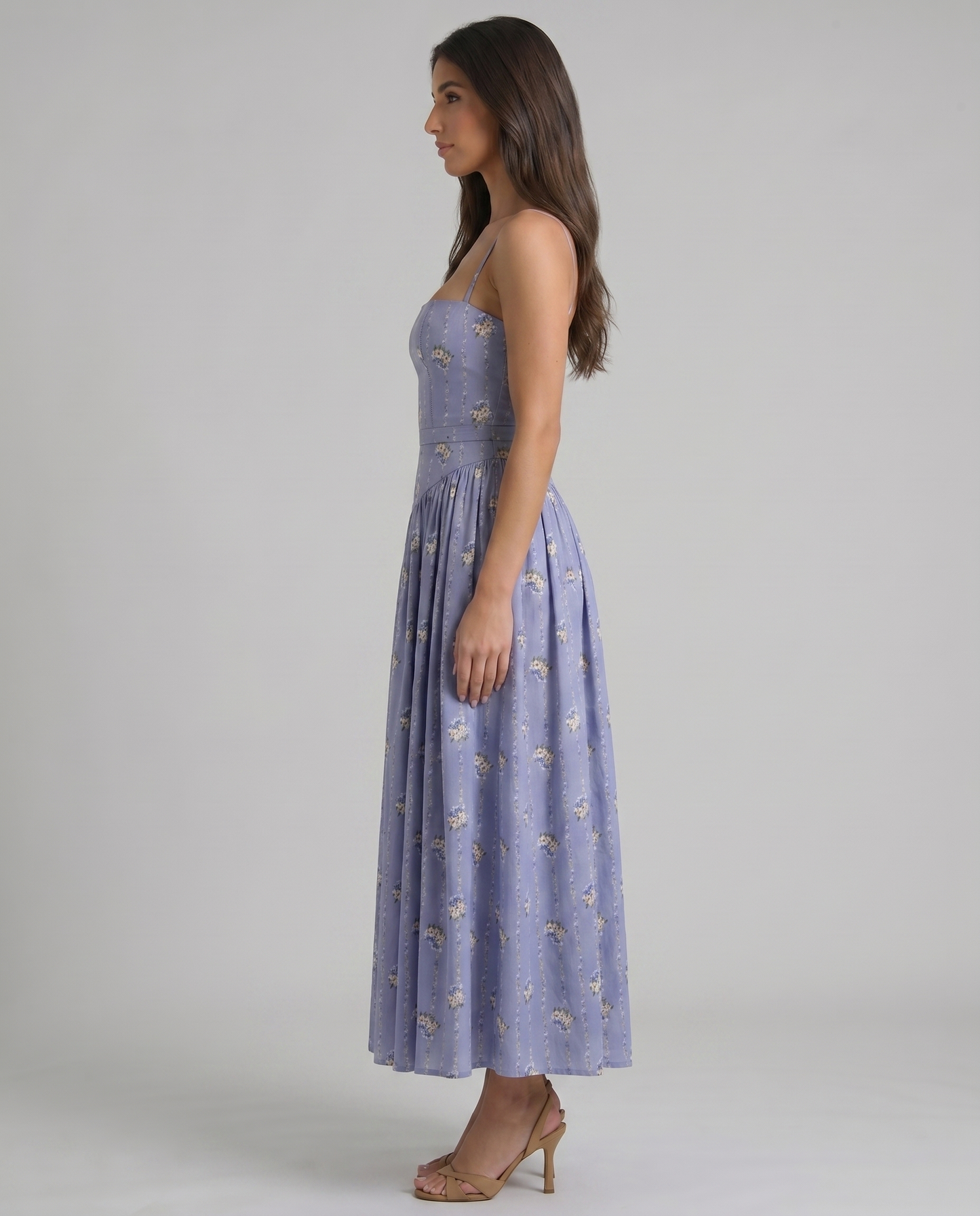 Side profile of violet floral midi dress with straight bodice, defined waist seam and airy skirt