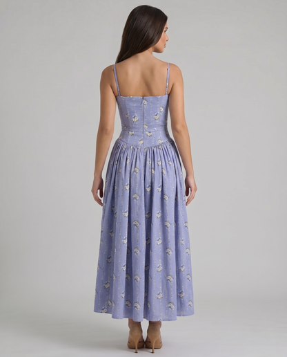 Back full-length view of violet midi dress with floral pattern, slim straps and gathered skirt volume