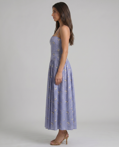 Full-length side view of violet floral midi dress highlighting the A-line skirt drape and waist panel