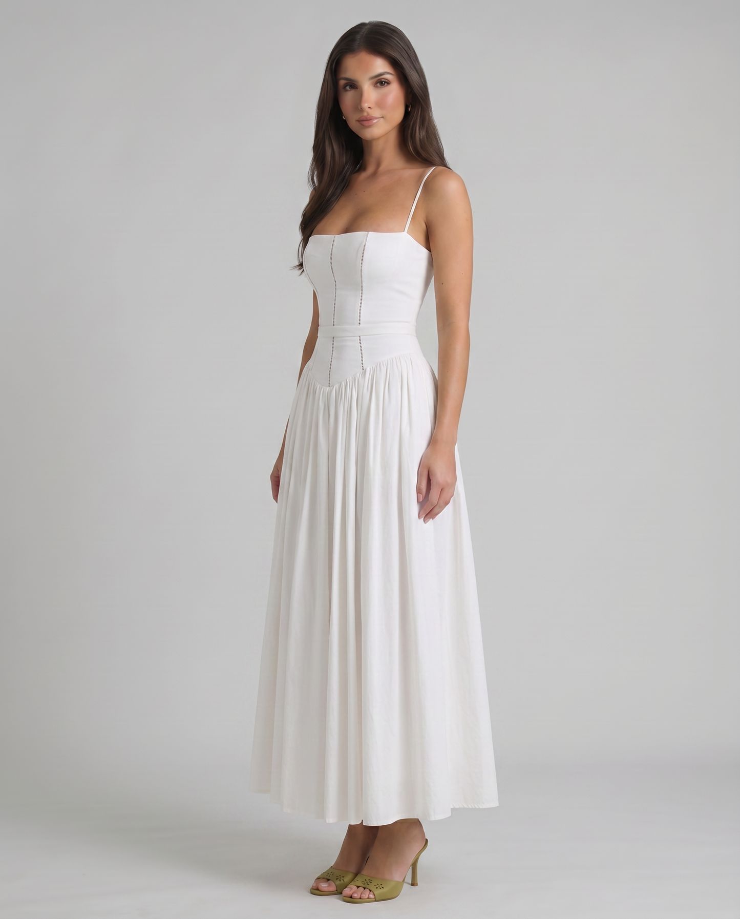 Angled front view of white midi dress with square neckline, seam detailing and full skirt