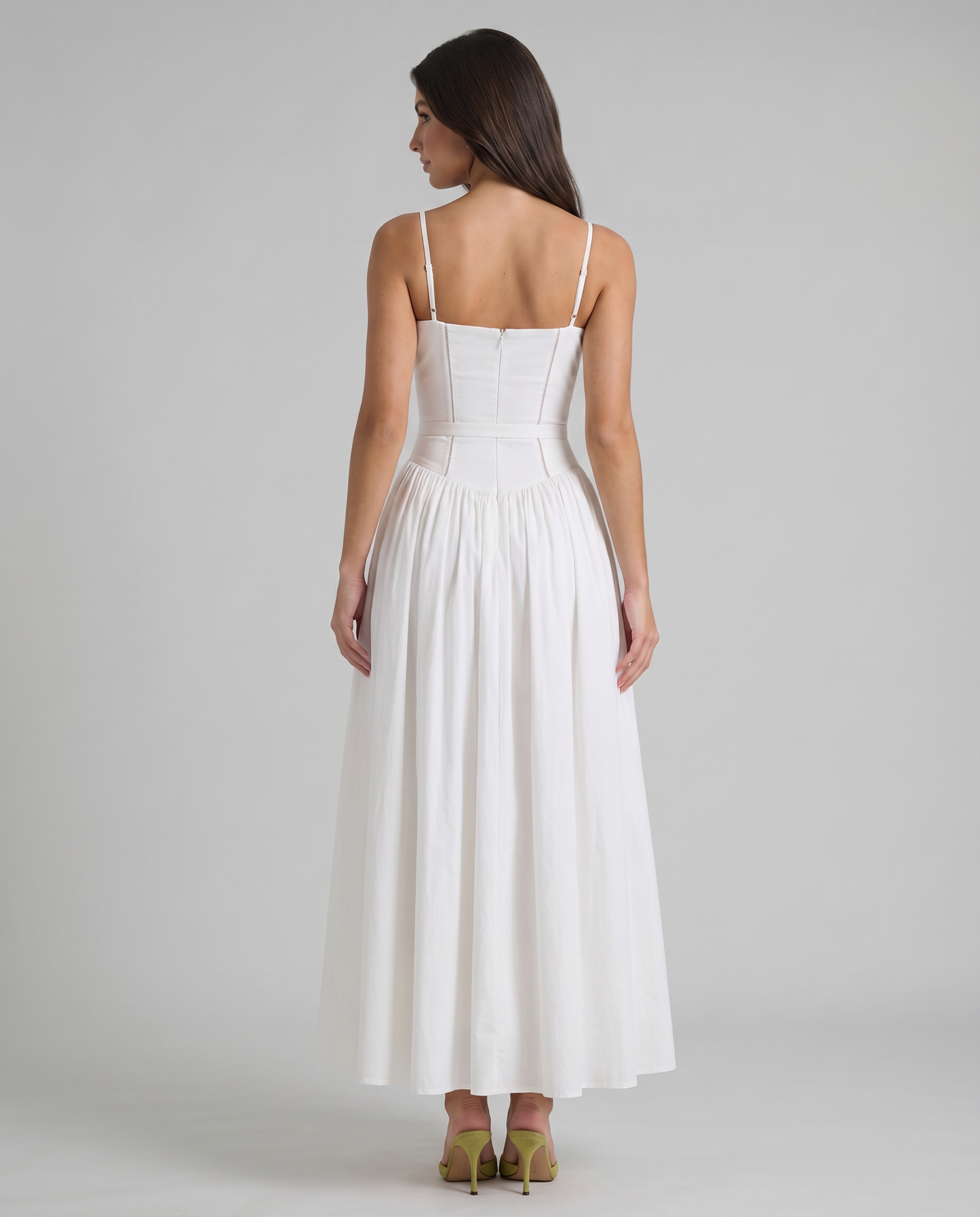 Back view of white midi dress showing thin adjustable straps, center back zipper and gathered skirt