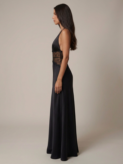 Side profile of black halter maxi dress showing smooth drape, fitted lace waist, and floor-length hem