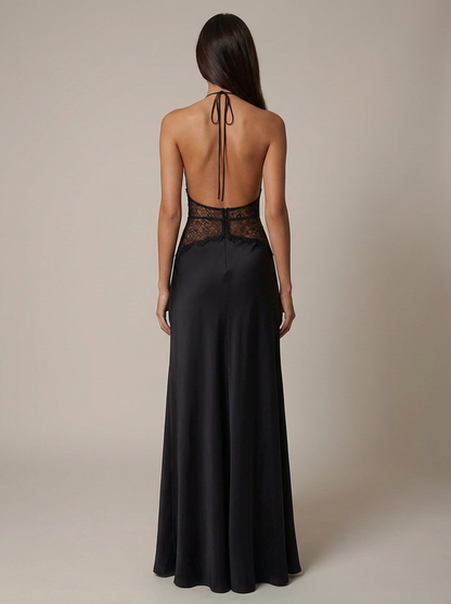 Full back studio view of black maxi dress with halter neck tie, open back, lace waist, and long skirt