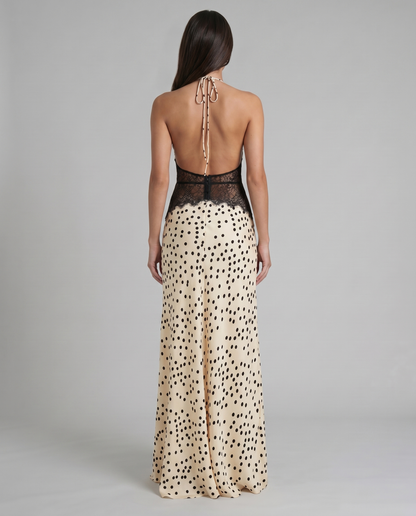 Back view black and white polka dot maxi dress with open back halter tie and lace waist panel