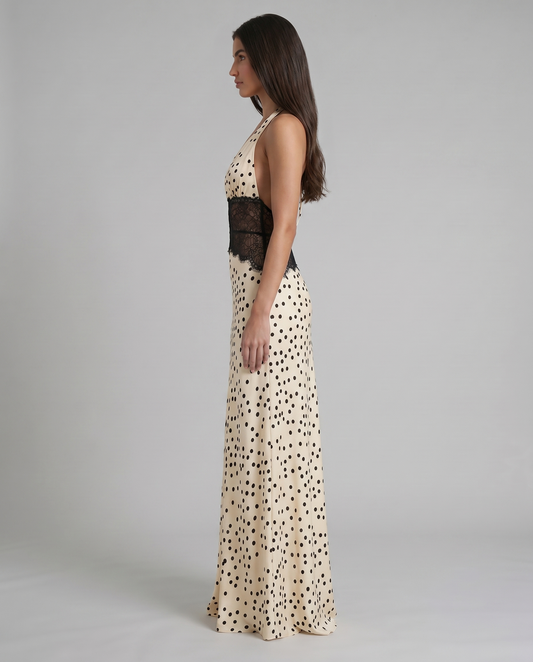 Full back length view of black and white polka dot maxi dress with lace waist and center seam