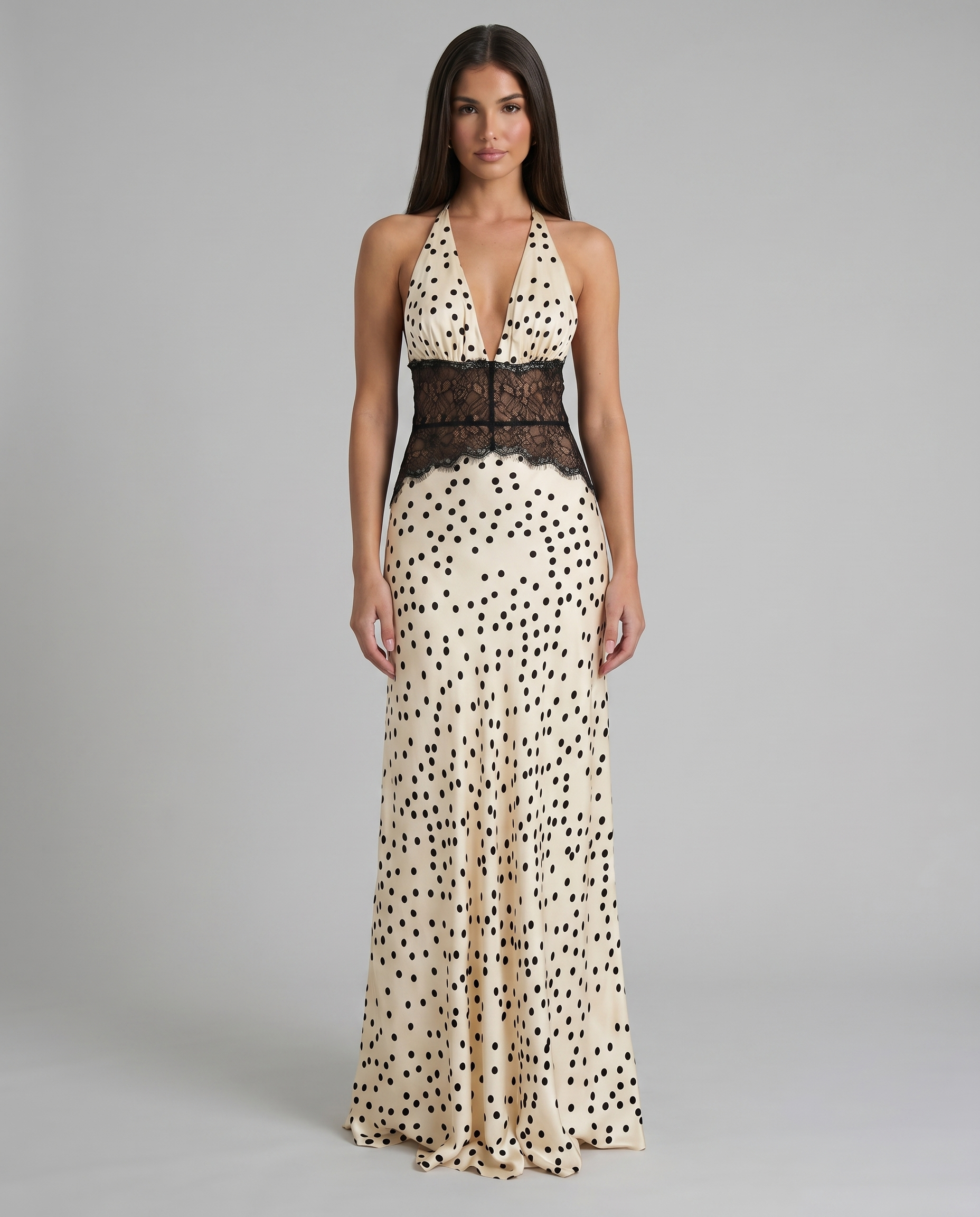 Front view black and white polka dot maxi dress with halter plunge neckline and lace waist