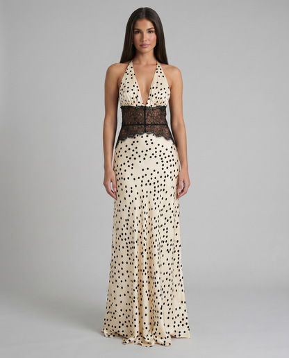 Front view black and white polka dot maxi dress with halter plunge neckline and lace waist