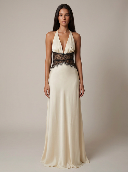 Full-length white maxi dress on neutral background with flowing hem and black lace waist accent
