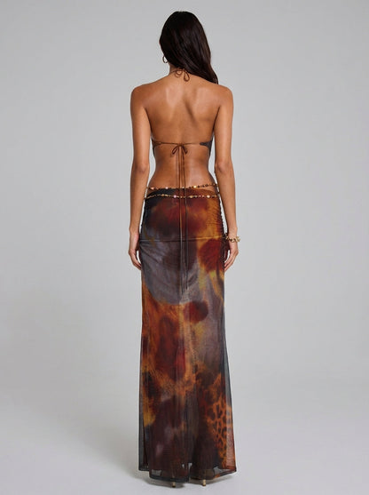 Back view of multicolor halter backless maxi dress with tie straps and beaded waist chain