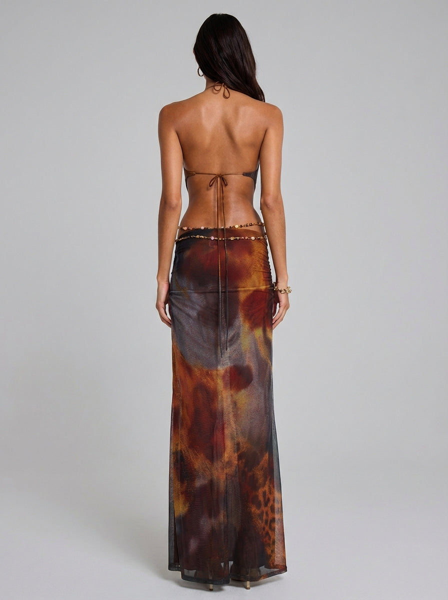 Rear full-length multicolor printed maxi dress showing ruched hips, open back and long tie closure