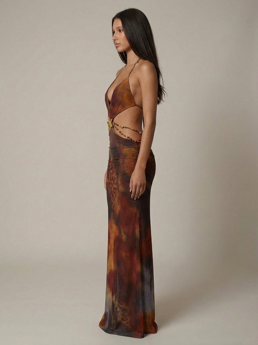 Side view of multicolor maxi dress with halter straps, open sides and beaded waist chain detail