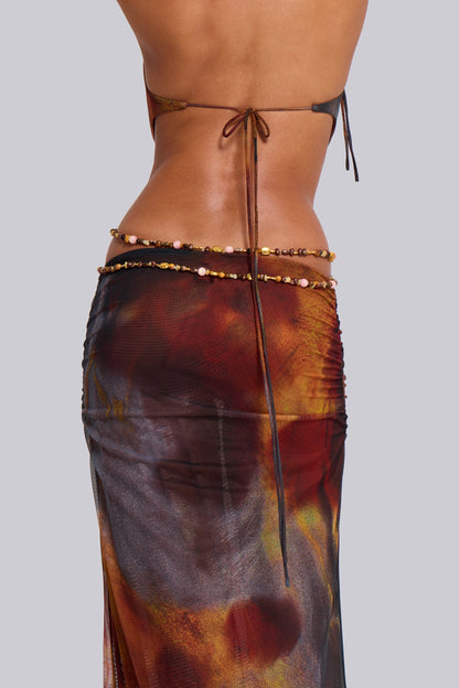 Back close-up of multicolor halter maxi dress with tie-back straps, low back and beaded waist chain