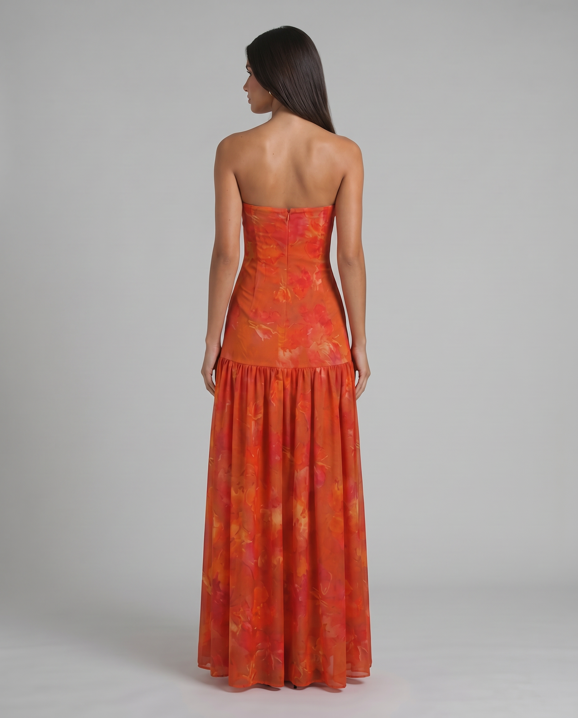 Back view red strapless maxi dress showing center zipper and fitted bodice with flowing skirt