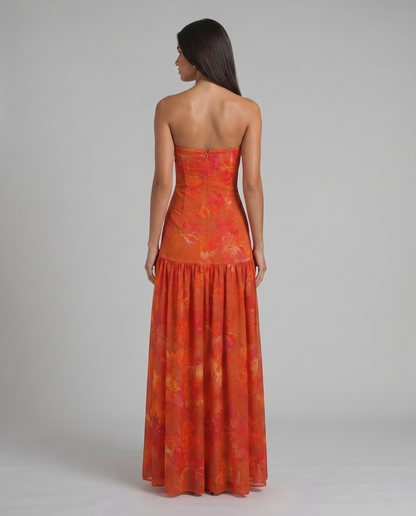 Back view red strapless maxi dress showing center zipper and fitted bodice with flowing skirt