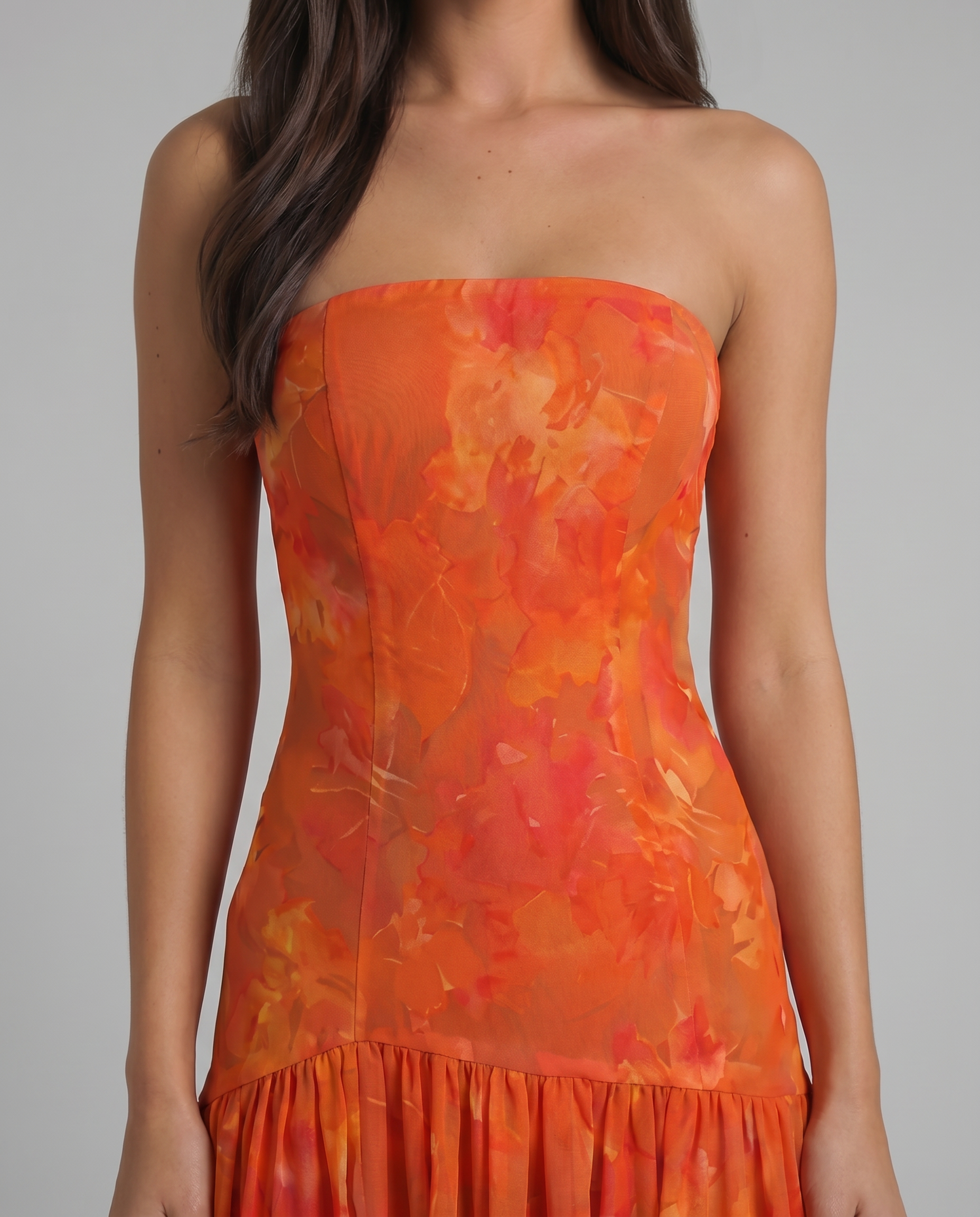 Close-up of red strapless maxi dress bodice with watercolor floral pattern and straight neckline