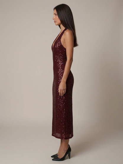 Back view of red sequin halter midi dress with low open back and straight midi hemline